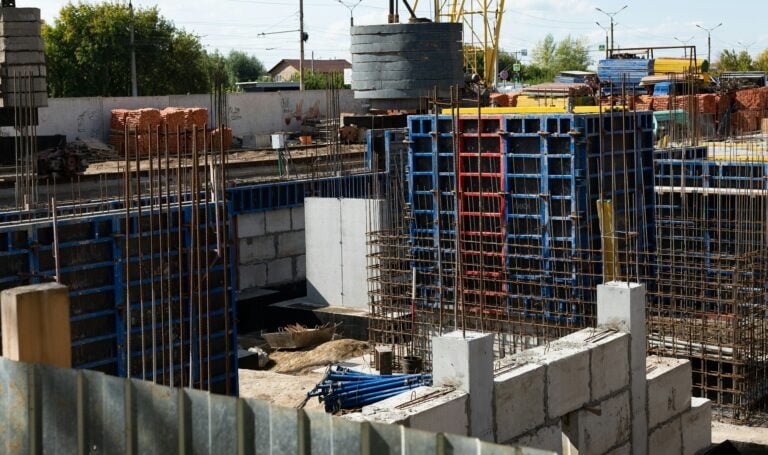 Concreting work at the construction site. Construction workers pour liquid concrete from cement c