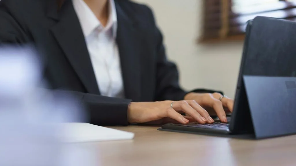 Secretary concept, Female secretary is working and typing report of business on tablet in office