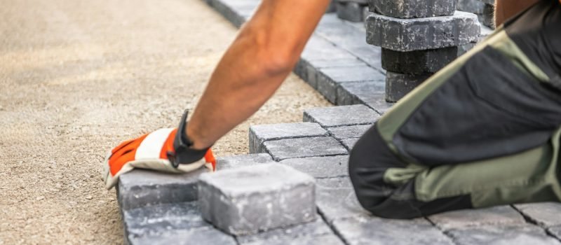 Laying Paving Stones on a Pathway in Bright Daylight